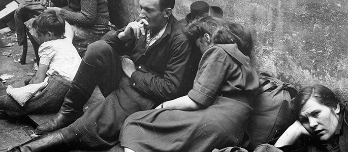 Holocaust survivors wait by the Jelen hotel, en route to Western Europe. Czechoslovakia, 1946