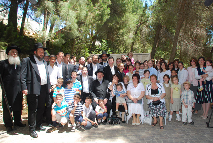 Rabbi Lau’s family and the daughters of the rescuer in a group photo in the Garden of the Righteous Among the Nations where Feodor Mikhailichenko's name is inscribed