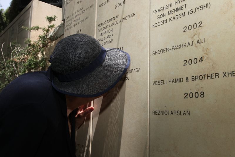 Vera Uglješić, saved by the rescuers and married Zlatan Uglješić after the war, kissing Zlatan's name on the wall, Garden of the Righteous, Yad Vashem, 29 May 2013