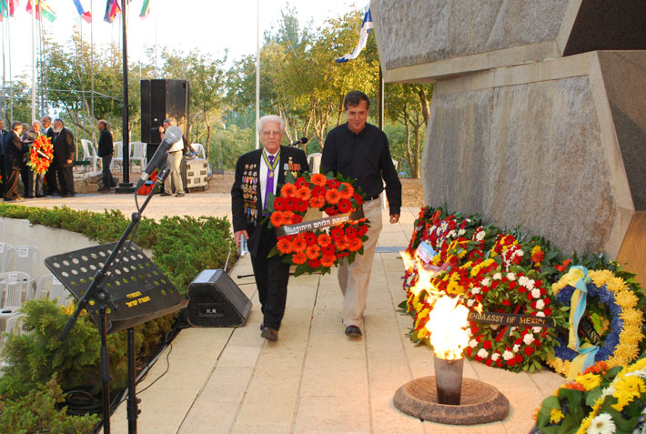 A veteran and his son lay a wreath