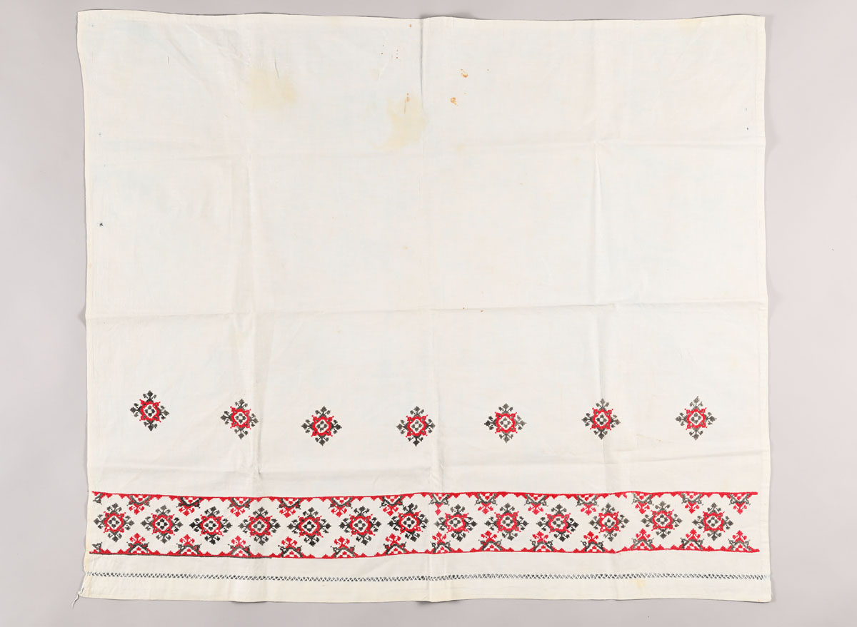 Tablecloth embroidered by Righteous Among the Nations Rozalia Shevchuk, while sitting on the chair that concealed the hideout of Dzyunya Vandner
