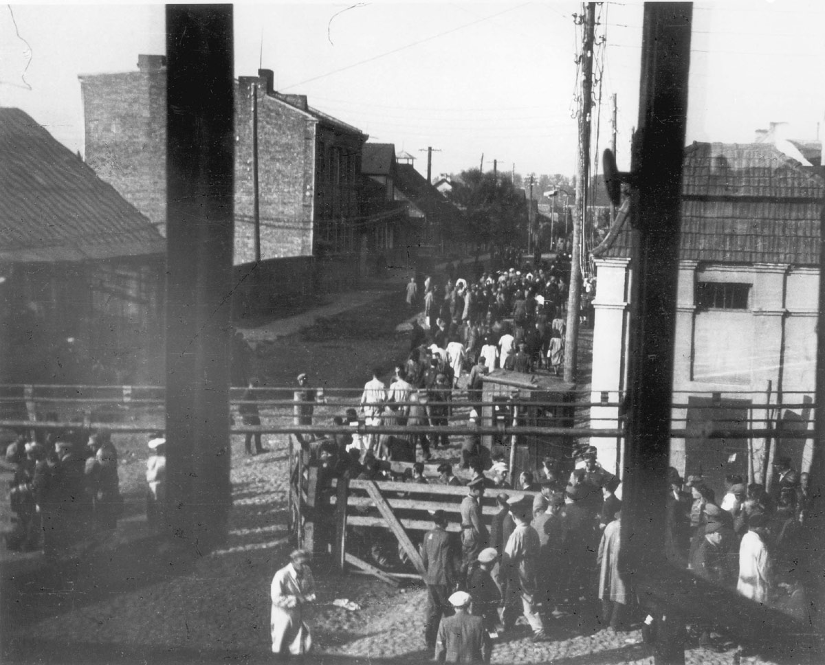 Ghetto Kovno inmates leaving via the main ghetto gate for forced labor duties outside the ghetto.