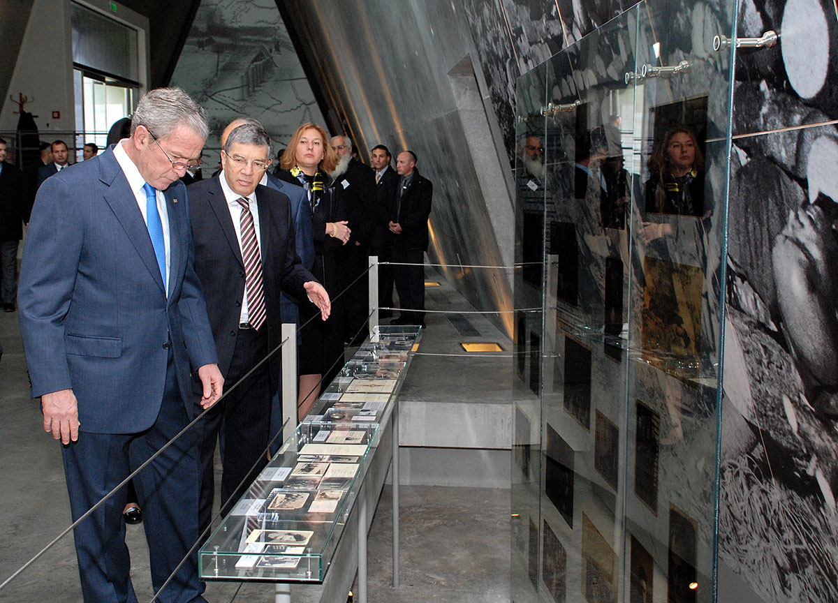 President Bush, guided by Chairman of the Yad Vashem Directorate Avner Shalev, studies an exhibit in the Holocaust History Museum