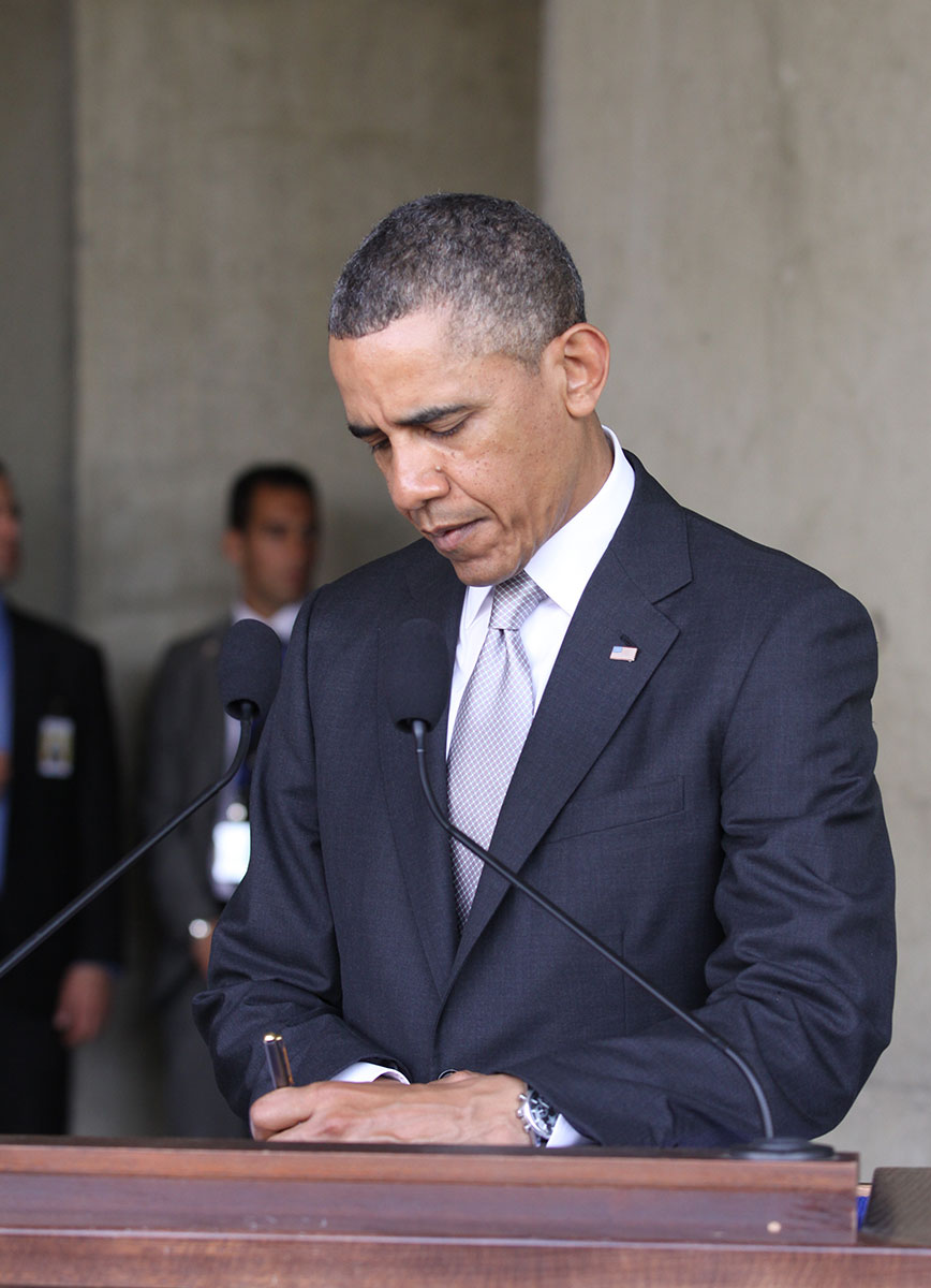 President Barack Obama signs the Visitors' Book at the conclusion of his visit