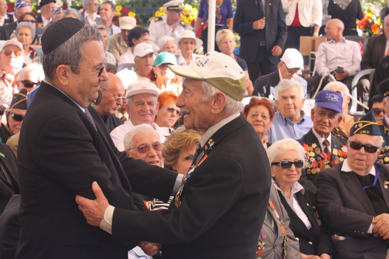 Minister of Defense Ehud Barak greets a veteran