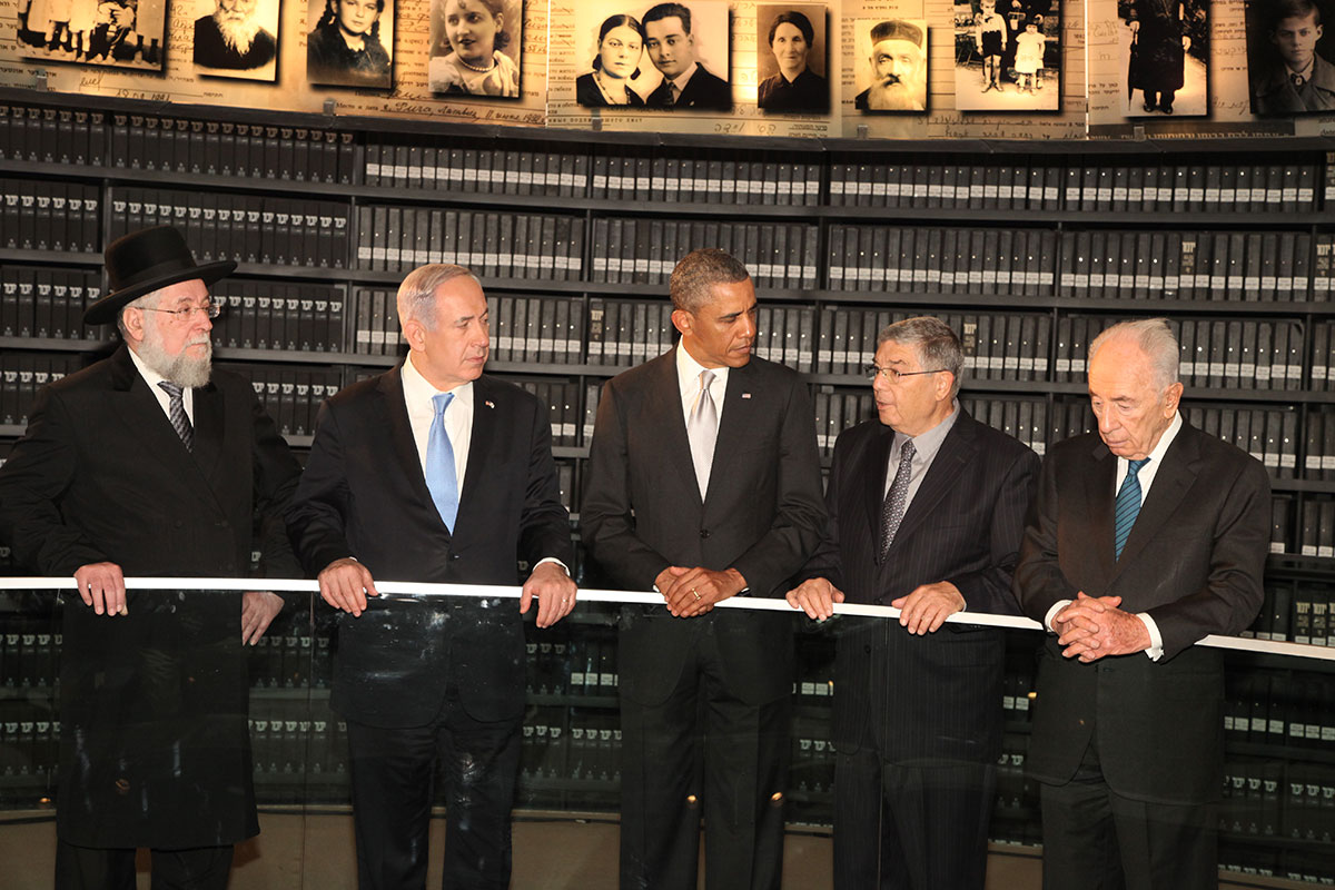 President Barack Obama listens to an explanation in the Hall of Names by Chairman of the Yad Vashem Directorate Mr. Avner Shalev