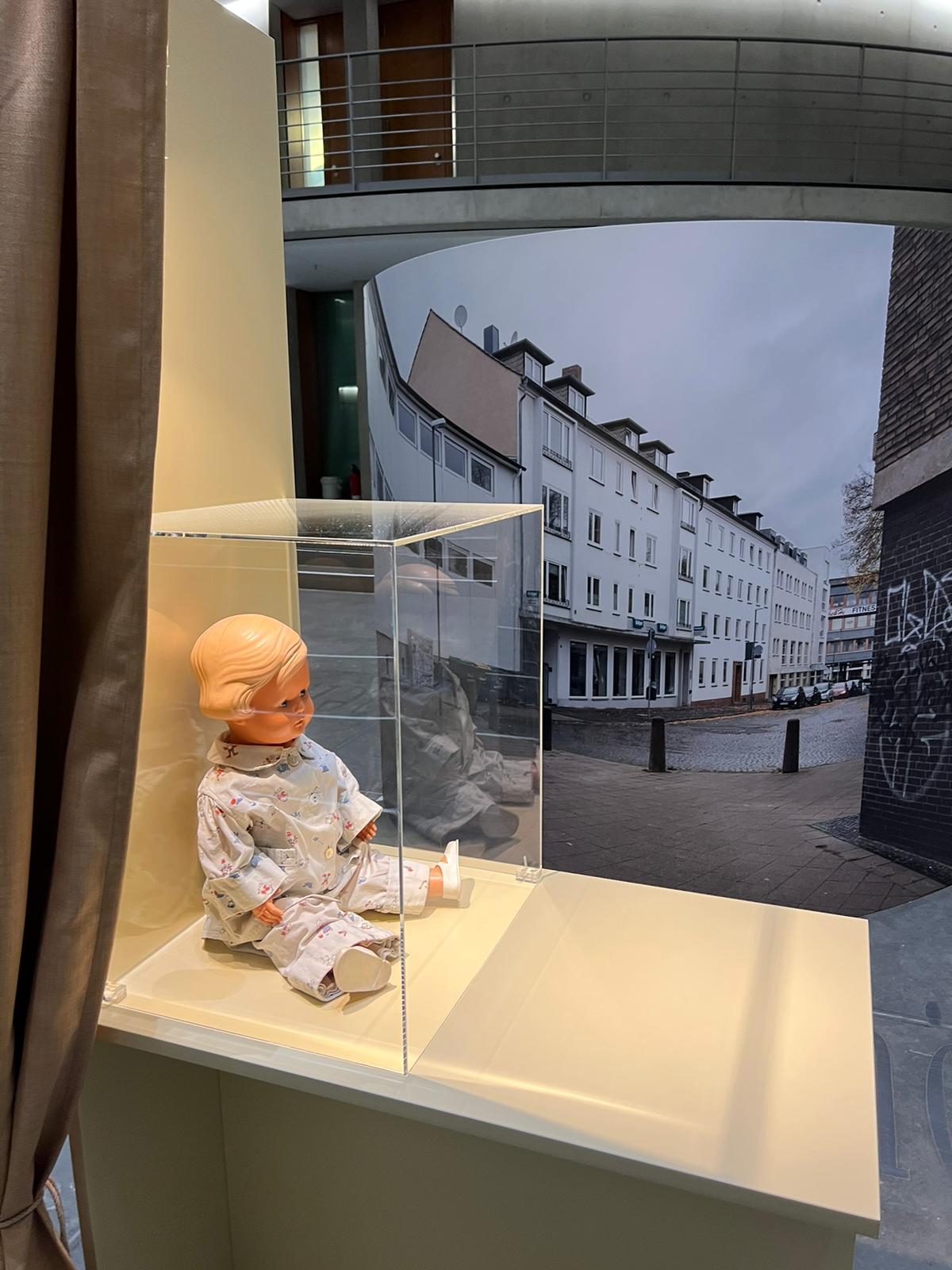 Lore Mayerfeld Stern's doll Inge against the backdrop of modern-day Kassel, where Lore grew up