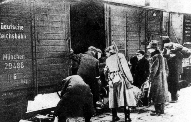 Jews boarding a train in Lodz for deportation