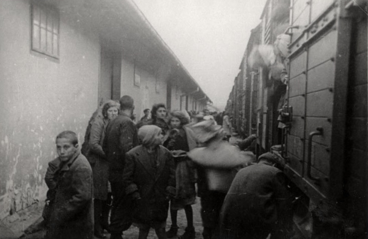 Tracia, Grecia, Deportados esperando frente a vagones de tren durante una deportación
