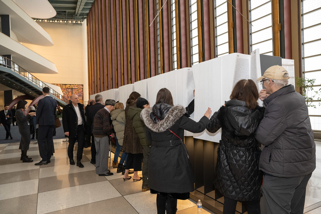 Miembros del público miran el Libro de los Nombres recién instalado en la Sede de la ONU, Nueva York