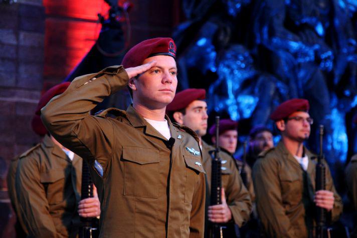 A soldier salutes during the Holocaust Remembrance Day State Opening Ceremony. 