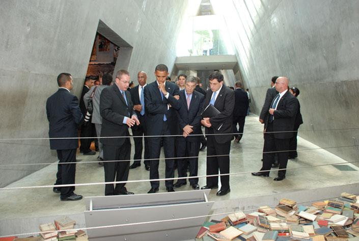 Senator Barack Obama studies an exhibit in the Holocaust History Museum; to his right is Israel's Ambassador to the United States Sallai Meridor