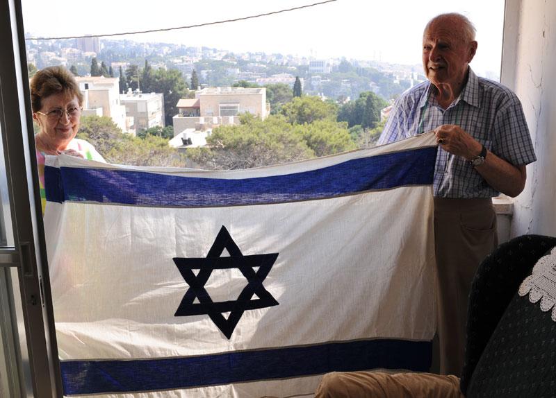 Moshe and Frieda with the flag at home