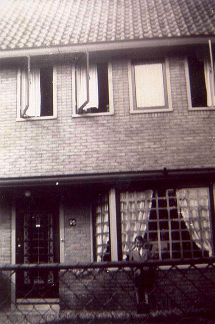 The youth W. Niemoeller in front of his home during the war. Note the front window crossed with tape because of the bombings. Hilversum, Holland, 1942