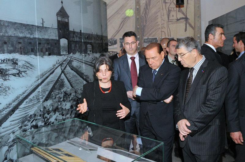 Italian Prime Minister Silvio Berlusconi studies the Auschwitz Album in the Holocaust History Museum. From the right: Chairman of the Yad Vashem Directorate Avner Shalev, Berlusconi, Education Minister Gideon Sa’ar, and Dr. Iael Nidam-Orvieto