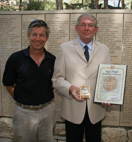 Henk Brink, son of Henk Drogt, holding his father’s certificate and medal of honor of the Righteous Among the Nations, with El Al pilot Mark Bergman in the Garden of the Righteous