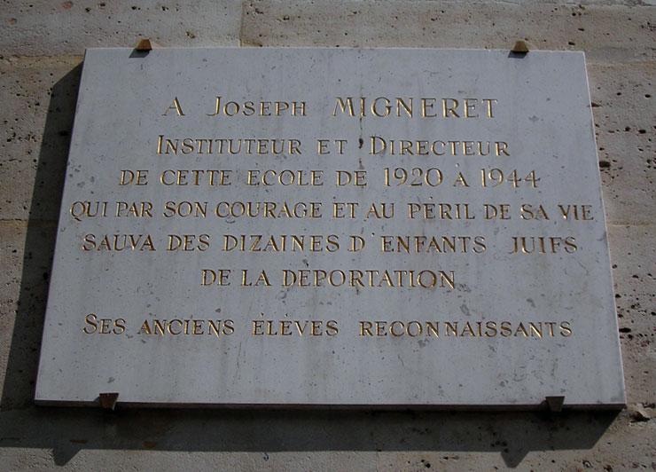 Plaque on the school building in memory of Joseph Migneret, installed by his former students