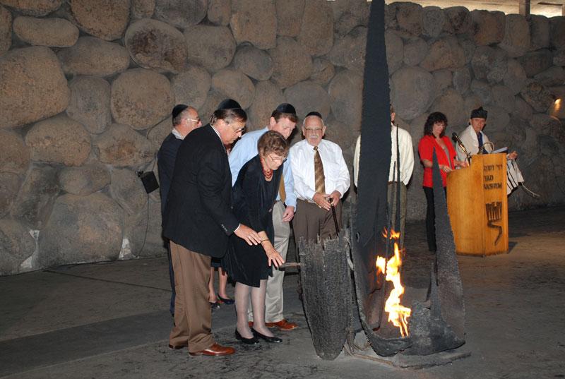 The children of Hein and Martha Snapper rekindle the Eternal Flame in the Hall of Remembrance