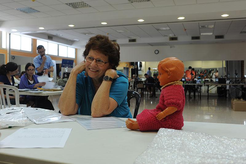 Vera Brand donating the doll she received in Karachi when she was on her way to Eretz Israel with the “Teheran Children”, July 2011