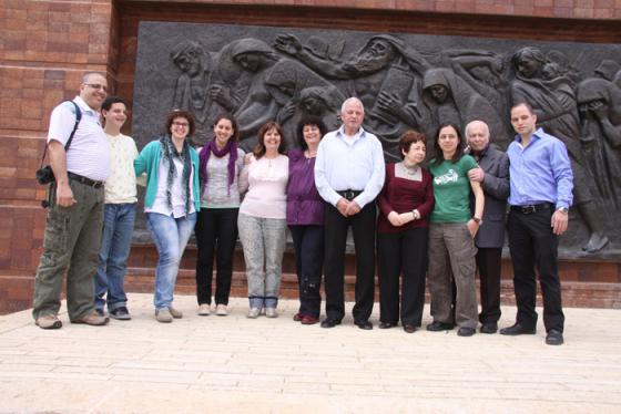 Cousins Liora Tamir and Aryeh Shikler pictured with their extended families after meeting for the first time at Yad Vashem's Warsaw Ghetto Square
