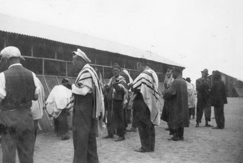 A group of men praying in Gurs Camp, France