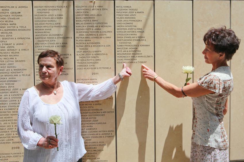 Holocaust survivor Karolina Eisen (Agatstein) and Elizabeth Stradowska, great-niece of Righteous Among the Nations  Zygmunt and Ludwika Szostak, next to the Wall of Honor in Yad Vashem's Garden of the Righteous Among the Nations, 13 May 2013.