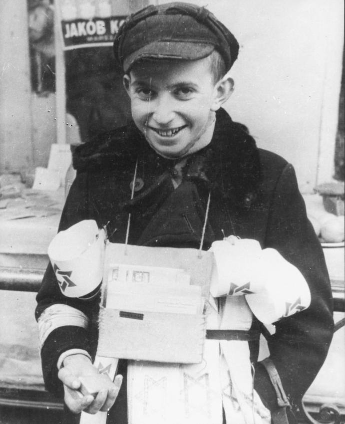 A young man in Poland selling armbands. 