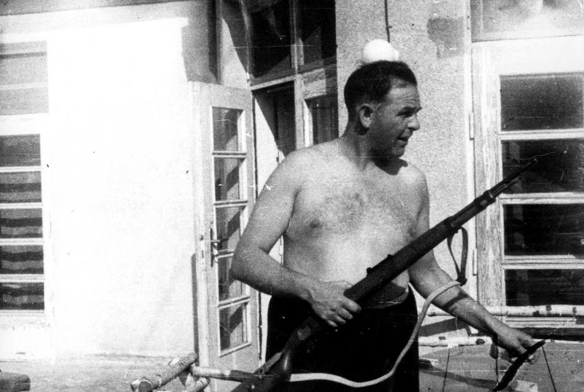 The camp commandant, Amon Goeth, armed with a rifle on the balcony of his house in Plaszow 