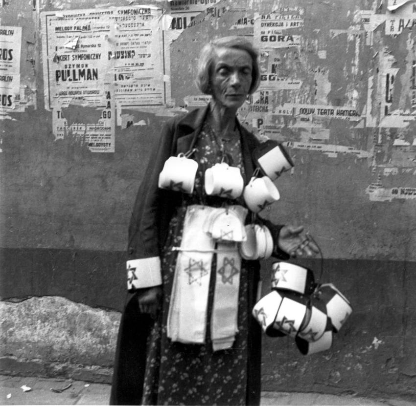Woman in Poland selling armbands, 1941.
