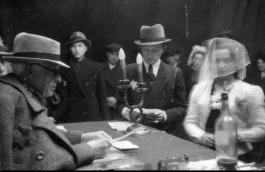Mordechai Rumkowski (from left), chairman of the Judenrat in the Lodz ghetto, officiating at a wedding