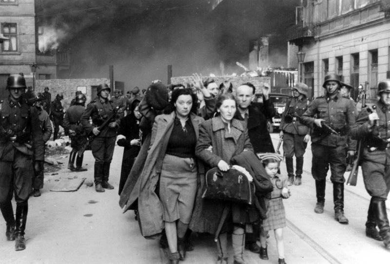 Soldados de las Waffen SS y líderes judíos capturados durante la represión de la rebelión del gueto de Varsovia en la Umschlagplatz. En la foto original en el álbum de Stroop, al pie dice: «Sacados a la fuerza del búnker»