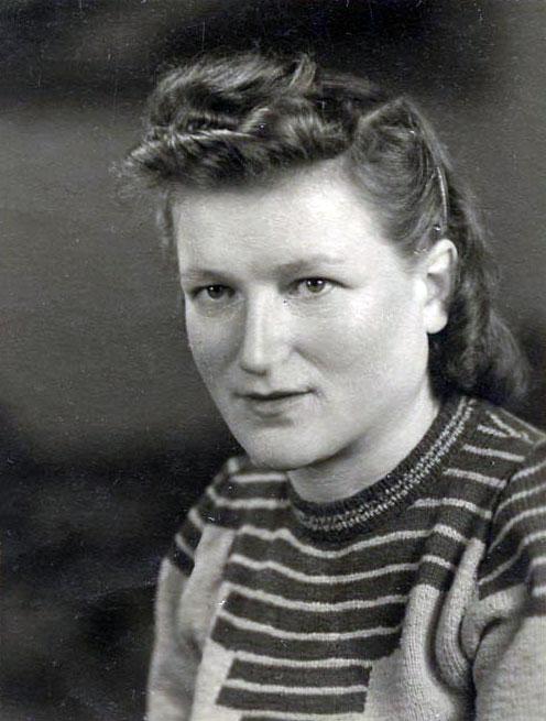 Gucia Wald Teiblum wearing the sweater she knitted from the wool of unraveled soldiers’ socks, Bergen-Belsen DP camp, 1947
