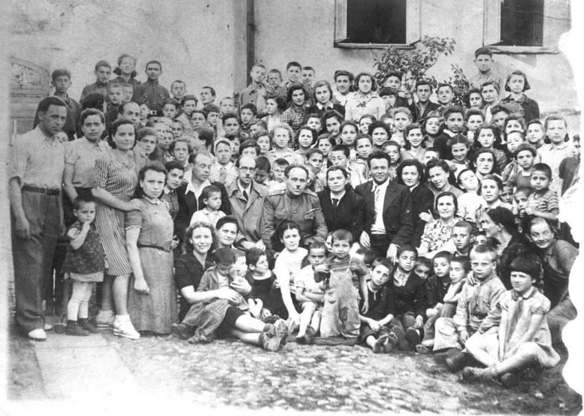 The Jewish Orphanage in Vilna, 1944. Front row, 4th from left, kneeling, in a grey dress: Zlata (Zehava) Burgin. Center, in uniform: Prof. Rabelski, the 'Father' of the orphanage