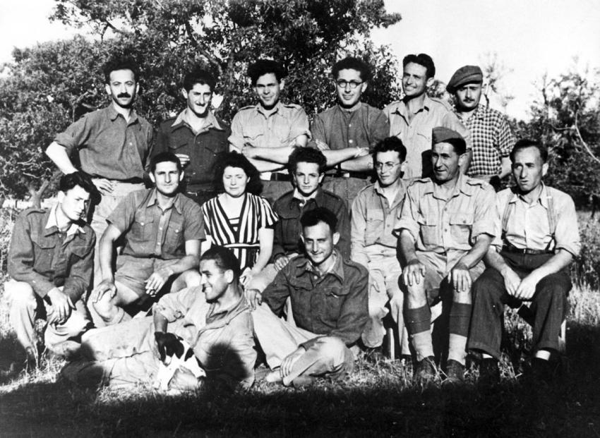 Soldiers from Eretz Israel serving in the British Army with young Jews in the Hachshara (Pioneer Training Collective) in Bari, Italy, 1944. In Bari, there was a refugee camp housing Jews and non-Jews. In 1947, some 780 Jews lived in the camp.
