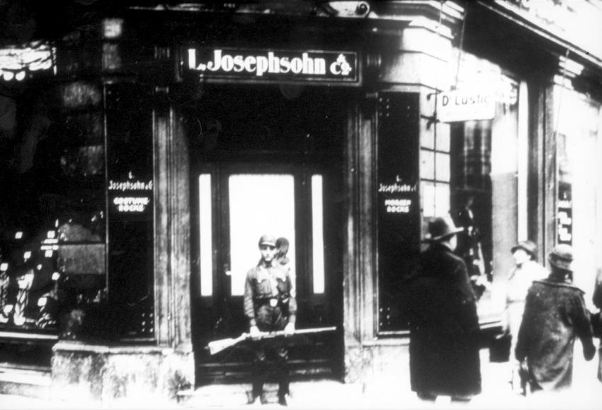 Boycott day of Jewish stores, 1 April 1933: a Jewish store in Regensburg under the watch of an SA guard to ensure that the boycott was carried out.