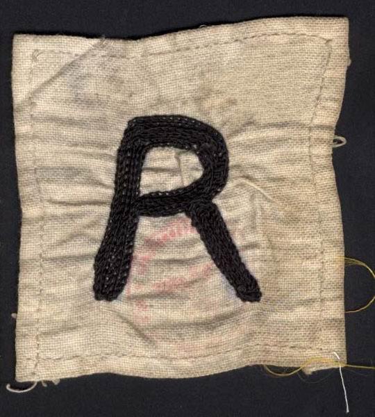 Badge with the letter R