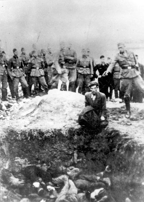 Vinnitsa, Ukraine, An SS man shooting a man's head over a mass grave, probably 1941