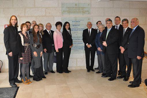 Holocaust Survivor Joseph Gottdenker (to the right of the plaque), key benefactor of the new International Seminars Wing of the International School for Holocaust Studies, attended the opening ceremony of the new wing accompanied by his fiancée