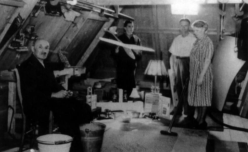 The workshop in the attic. From the left: Jakob. Behind his left shoulder is the edge of the table now in the collection at Yad Vashem. Joachim-Max is holding the model plane.