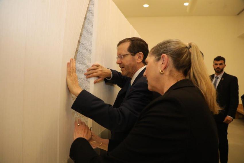 The President of the State of Israel Isaac Herzog and his wife, Michal, looking for names of their family murdered during the Holocaust