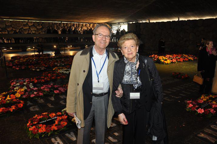 Georg and Elisabeth Citrom of the Holocaust Survivors Association, Sweden standing among the wreaths in the Hall of Remembrance 