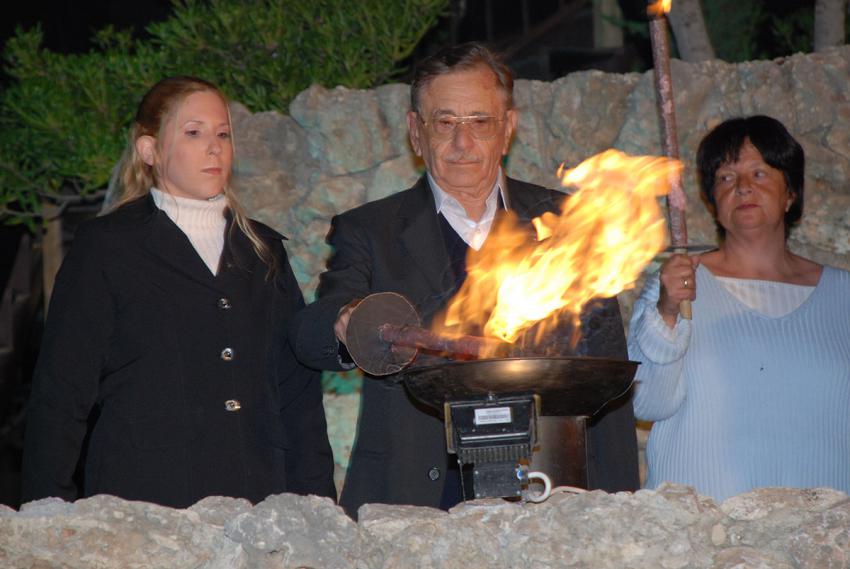 Holocaust survivor David Gur lights one of the six torches at the ceremony