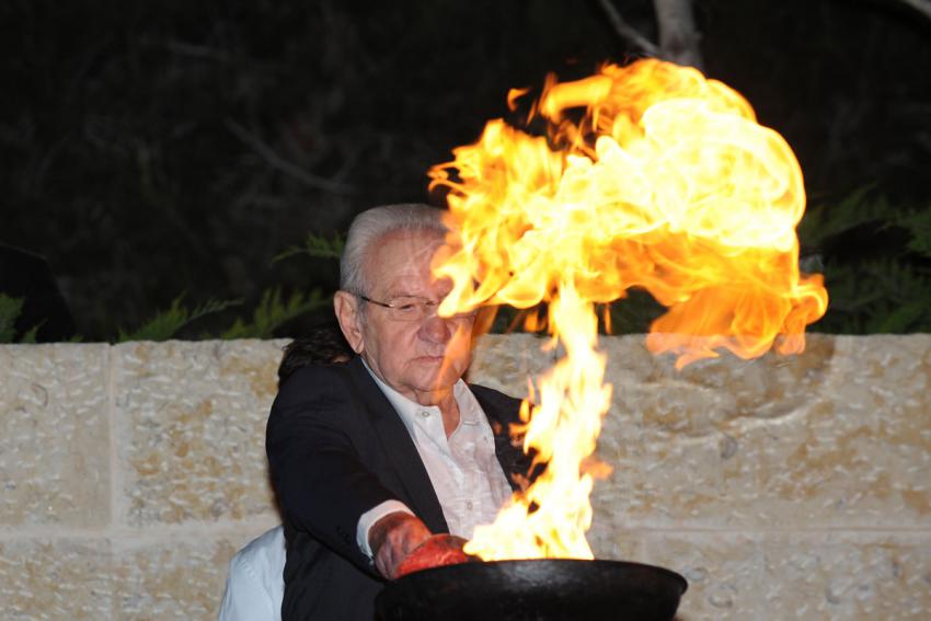 Holocaust survivor Yona (Janek) Fuchs lights one of the six torches at the ceremony
