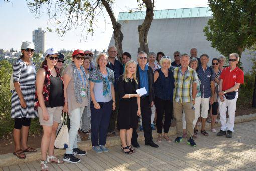 ICEJ Switzerland Feast Tour with National Director Hansjörg Bischof (front row, fifth from left) presenting a donation to Dr. Susanna Kokkonen (front row, fourth from left) in the Avenue of the Righteous at Yad Vashem on 19/10/2016