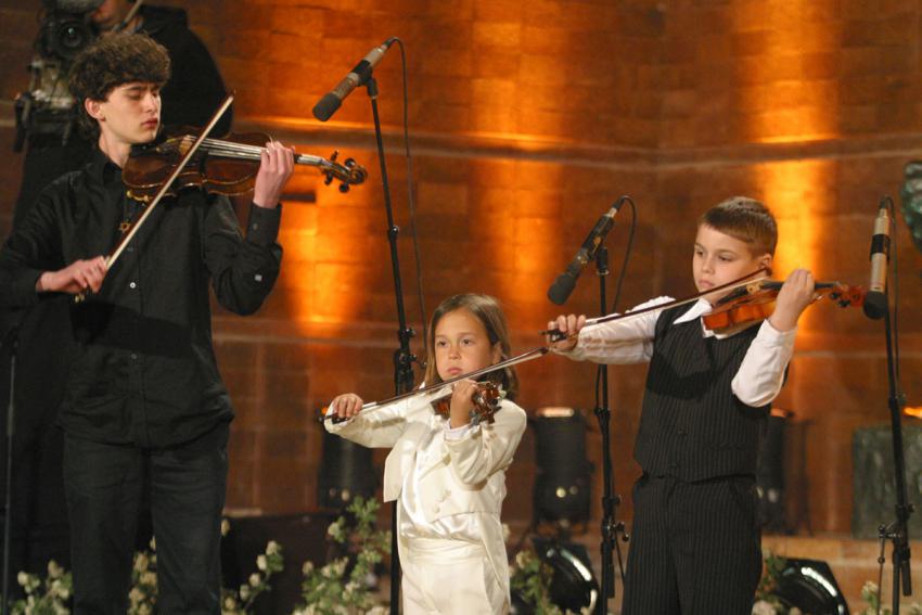 Violinist David Strongin (left), playing the violin that belonged to young partisan Motteleh Schlein, and violinists Michael Feigin (center) and Mark Karlinsky perform &quot;Eli Eli Lama Azavtani&quot;, a melody from Psalms Chapter 22
