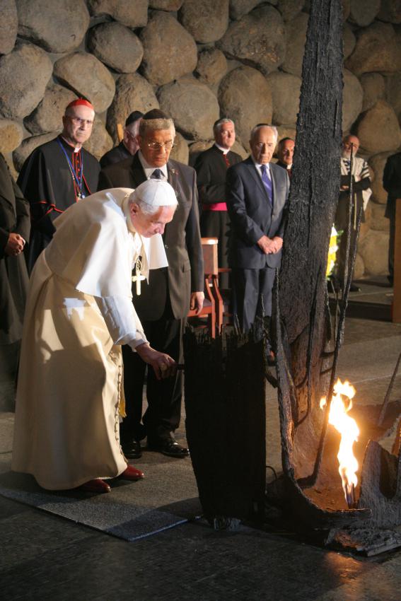 El papa avivando la llama eterna durantre la ceremonia conmemorativa en la Sala del Recuerdo