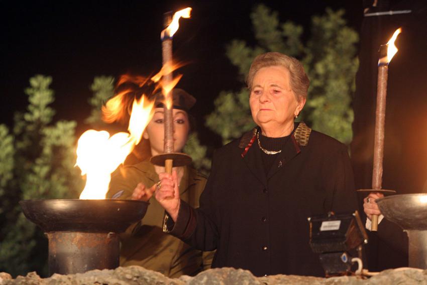Holocaust survivor Manya Brodeski-Titelman lights one of the six torches at the ceremony
