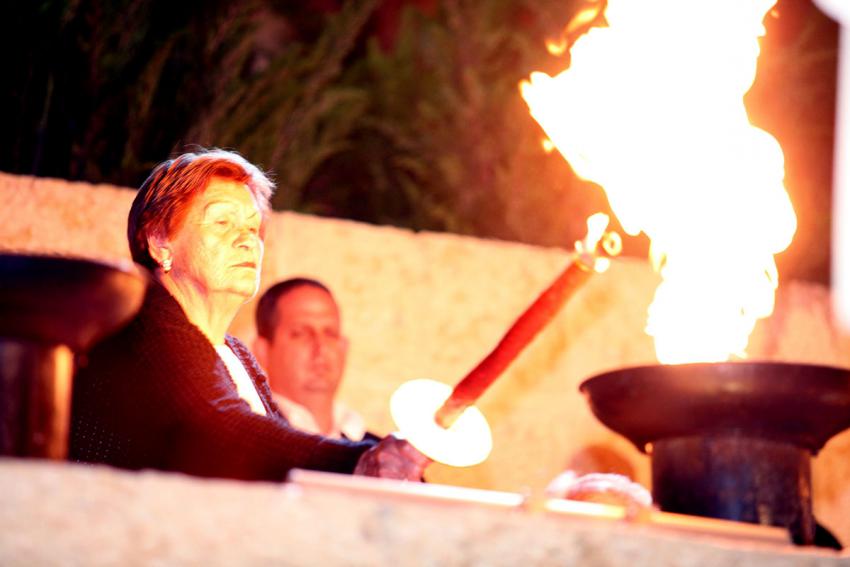 Holocaust survivor Miriam Liptcher lights one of the six torches at the ceremony