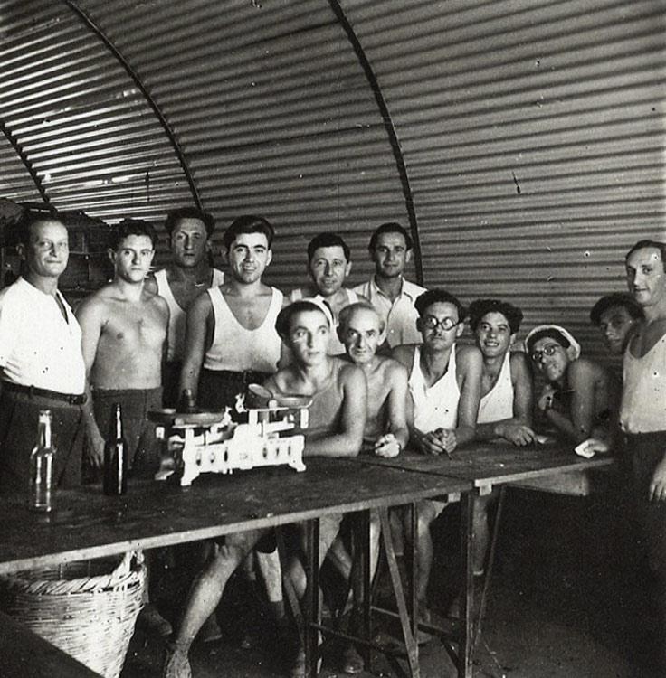 Moshe Joselewitz in the detention camp in Cyprus. Moshe is second from the left (with no shirt). Note the interior of the huts used in the camps in Cyprus.