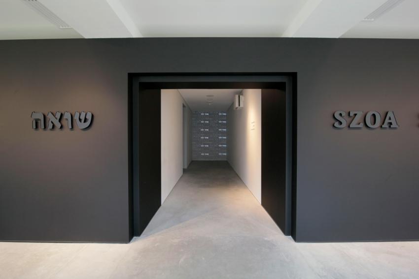 The entranceway to the exhibition displays the word Shoah and its definition in English, Hebrew and Polish